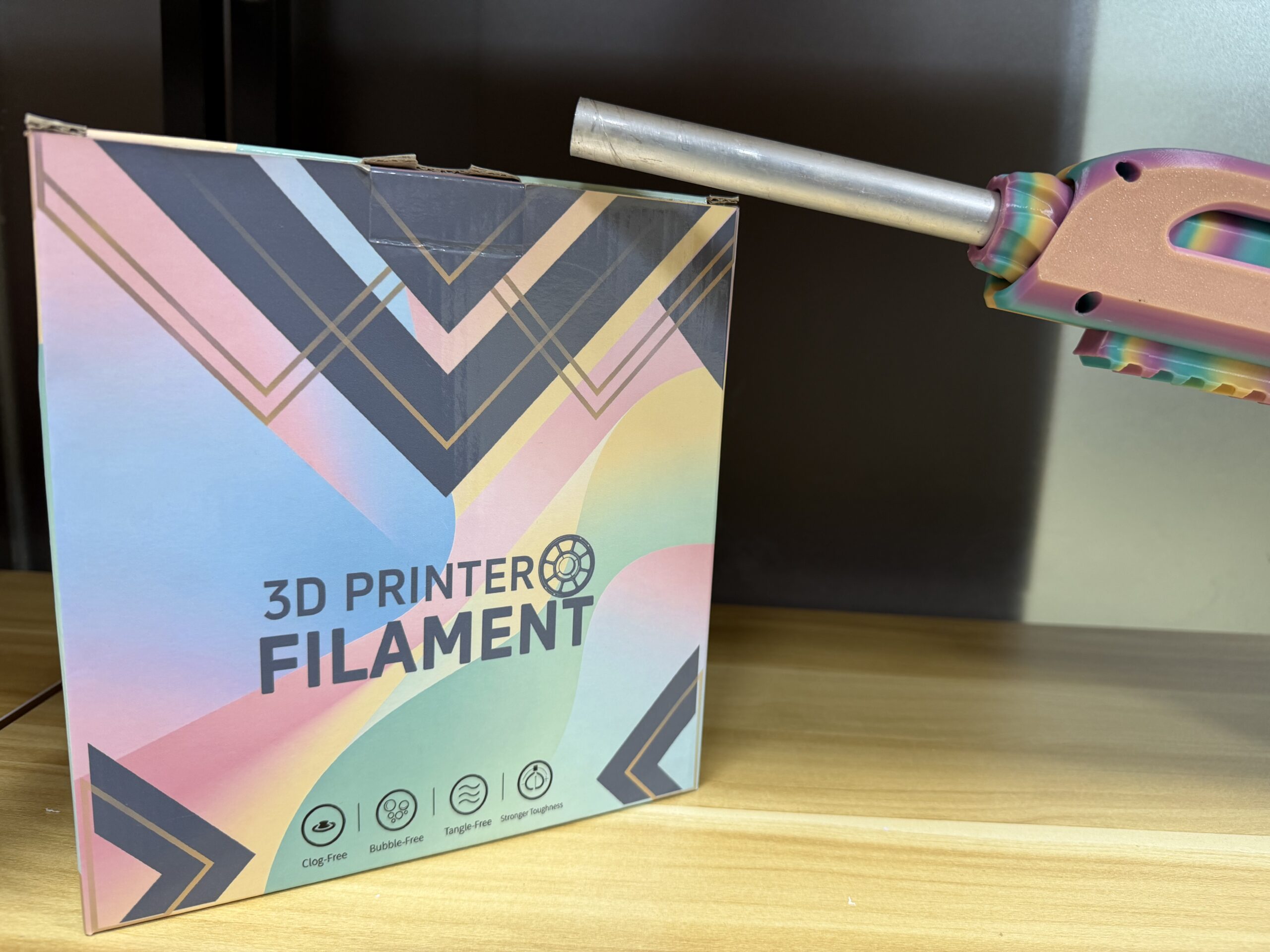 Filament spool beside early private-label packaging artwork