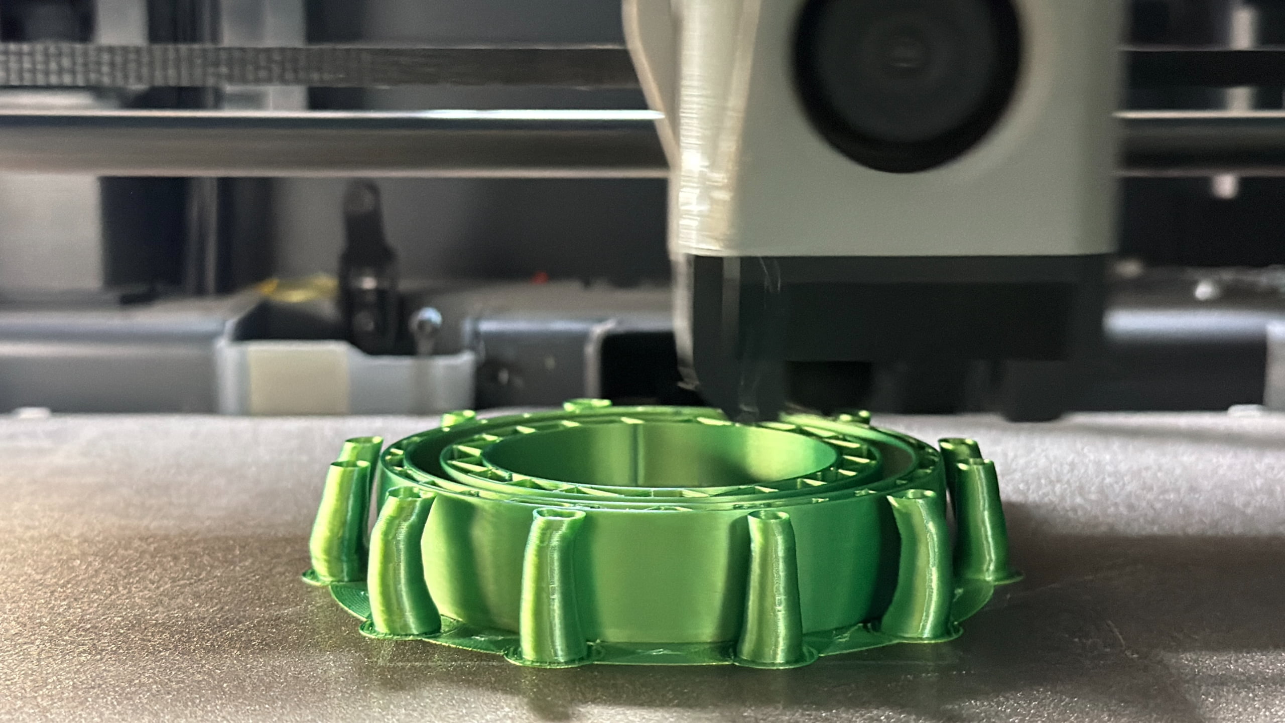 Green printed evaluation part photographed during a test run